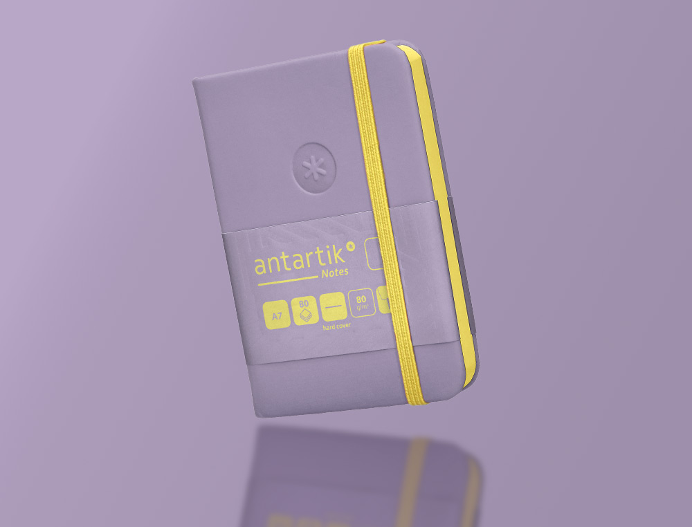 CADERNO COM ELASTICO ANTARTIK NOTES CAPA DURA A7 LISO ROXO E AMARELO 80 FOLHAS 80 GR FSC